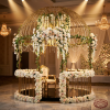 Gold birdcage dome decorated cascading florals hotel ballroom 45 degree warm spotlights