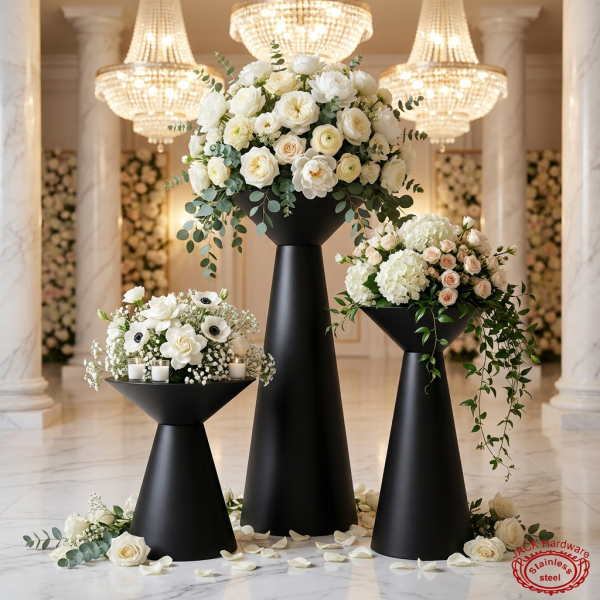 Matte black hourglass 3-piece stands at wedding floral display white roses chandeliers backdrop