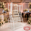 White champagne tower rack at grand wedding reception crystal glasses tiers