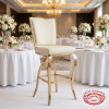 Gold ivory bar stool at upscale hotel banquet hall champagne glasses floral