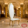 Gold ornate throne chair at upscale hotel lobby reception hall European architecture golden columns