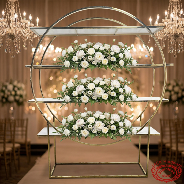 Gold circle ring display rack at luxury wedding ceremony space floral shelves crystal chandeliers