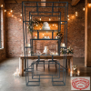 Geometric tiered display rack at industrial chic wedding with exposed brick Edison lights