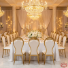 Gold S-curve crown dining chairs at grand wedding hotel banquet table chandeliers