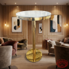 Champagne gold bar table at modern boutique hotel lounge warm wood gold accents