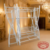 Trapezoidal champagne stand at luxury hotel ballroom golden ambient lighting chandeliers