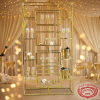 Asymmetric multi-shelf rack at champagne wedding bar fairy lights ivory drapes