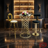 Gold Moroccan bar table 2 stools set at luxury hotel bar counter dark moody gold accent lighting