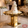 Gold T-shape cake display at hotel wedding tiered wedding cake roses gold column 45 degree