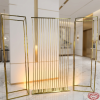 Gold screen set as modern hotel lobby corridor elegant decorative partitions amber up-lighting marble