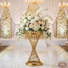 Gold spiral twisted column cocktail stand with white roses dome spiral column fretwork rim chandeliers
