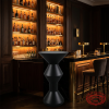 Black hourglass bar table at modern 5-star hotel cocktail bar backlit shelves dark elegant