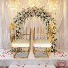 Gold tube throne chair pair at grand wedding venue bride groom seats white florals chandeliers