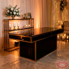 Black gold signing desk side view back shelf styled florals candles warm ambient