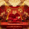 Red rose sculptural sofa at Chinese red wedding ceremony gold backdrop chandeliers main seat