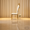 Gold S-curve crown chair side view wedding luxury event graceful S silhouette warm golden light