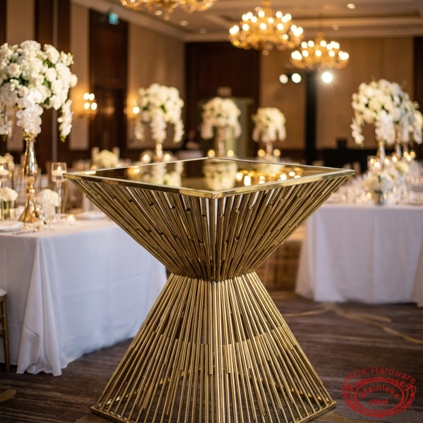 Gold X-hourglass bar table at upscale hotel ballroom pre-function floral event setup