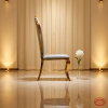 Gold crown wave chair side view luxury event crown silhouette cabriole legs warm golden light