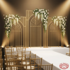 Gold arch grid backdrop at wedding stage white gold ceremony white roses aisle