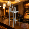 Arc ring bar stool at luxury hotel bar warm golden lighting