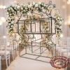 Silver arch circle ring backdrop at wedding ceremony white blush florals fairy lights aisle