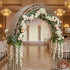 Silver parallel tube fan arch at hotel ballroom wedding backdrop cascading florals 45 degree