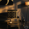 Black gold honeycomb barrel chair side view modern luxury interior honeycomb shadow warm light