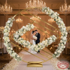 Gold diamond lattice circle arch at luxury wedding ceremony white roses woven through lattice chandeliers