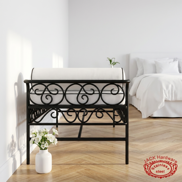 Black iron white cushion bench side view boutique hotel bedroom scrollwork shadows white marble dramatic