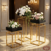 Gold frame black top square stands hotel wedding 45 degree grid pattern contrast warm spotlights