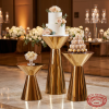Gold hourglass double-cone stands at hotel wedding reception 45 degree mirror reflection