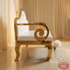 White gold Baroque loveseat side view wedding reception cabriole legs scrollwork warm golden light