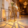 Gold geometric crosshatch column side view grand ballroom uplighting diamond shadow pattern marble