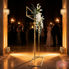 Gold rectangular floral hanger frame side view wedding entrance warm ambient uplighting