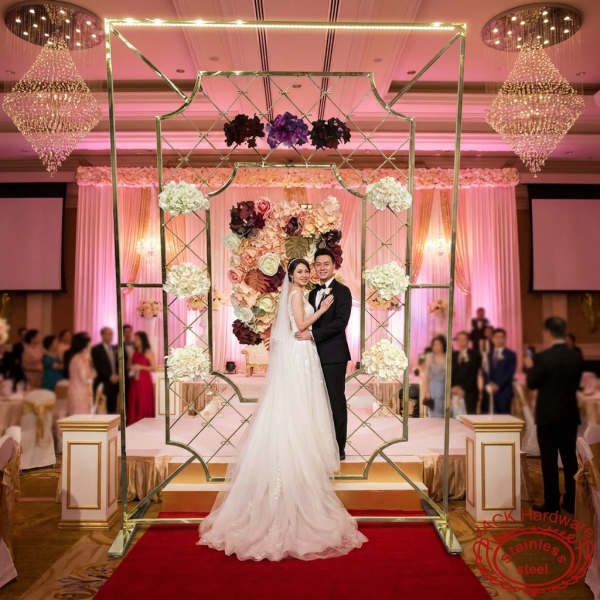 Gold diamond lattice floral backdrop at luxury wedding ceremony stage crystal chandeliers couple