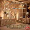 Gold semi-circular wine rack at hotel ballroom champagne themed wedding decor