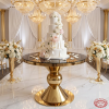 Gold double-cone ball-center cake table with tiered wedding cake roses chandeliers dark glass