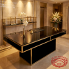 Black gold reception counter at hotel lobby check-in orchid gold frame spotlights 45 degree