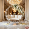 Large circular globe sofa at grand luxury hotel lobby art installation white cushion chandeliers