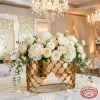 Gold fish-scale box with white peonies roses overflowing chandelier light scallop scales glow
