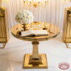 Gold round table at wedding signing station florals guest book chandeliers square column pedestal