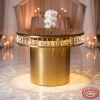 Gold cylindrical cake table side view wedding venue crystal sparkle prismatic rainbow uplighting orchid