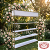 Gold frame white shelf at romantic garden wedding rose garlands golden bokeh
