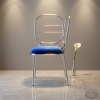 Silver open frame dining chair side view luxury interior clean modern silhouette blue cushion