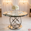 Silver Möbius ring abstract base table at wedding signing station florals guest book chandeliers