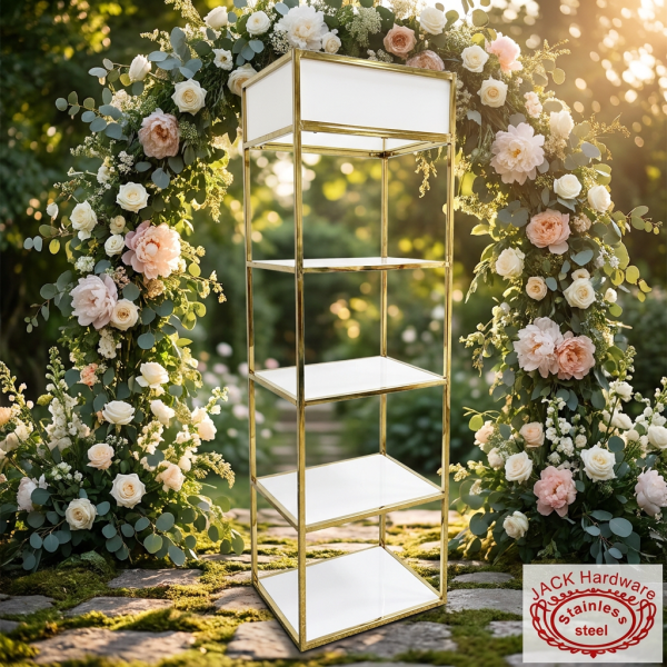 Gold white display shelf at romantic outdoor garden wedding floral arch golden hour bokeh