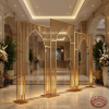 Gold gothic arch backdrop panels as hotel lobby room divider marble floors warm gold lighting
