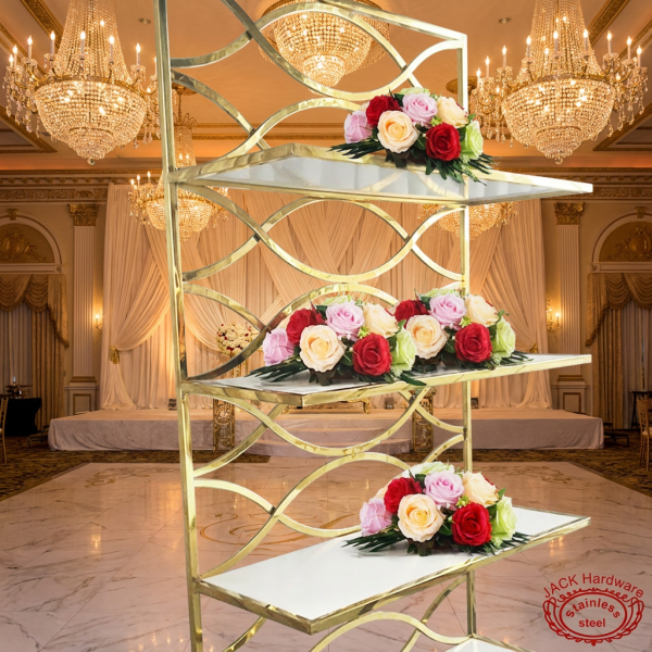 Gold wave lattice tall display rack at grand wedding ballroom crystal chandeliers floral shelves
