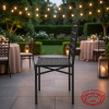 Black iron art chair at modern hotel outdoor terrace garden event string lights