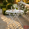 White lattice folding table at hotel terrace garden wedding florals 45 degree shadow pattern